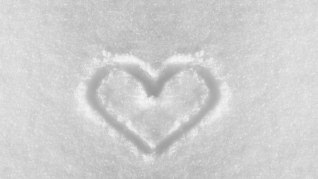 hand drawn heart shape in the fresh white snowの写真素材