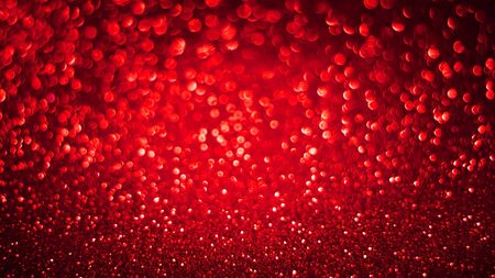 Red shiny blurred glitter bokeh holiday backgroundの写真素材