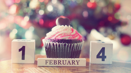 Chocolate heart on top of cupcake for valentine on colorful bokeh background vintage styleの写真素材