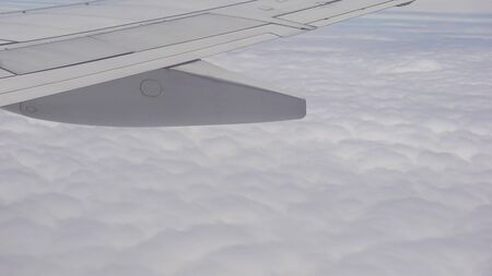 view from the airplane window, fluffy cloudsの写真素材