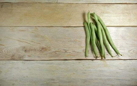 Green beans on wooden table backgroundの写真素材