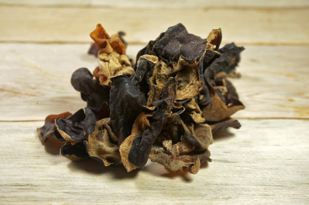 Dried Kikurage (wood ear mushroom, Jewâ€™s ear mushroom, fungus). Wooden background.