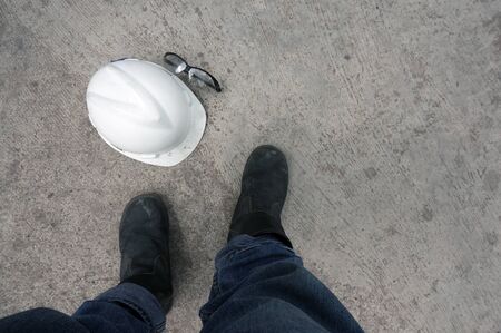 Helmet and  safety glasses on the floorの写真素材