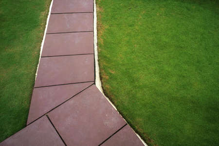 Concrete walk pathway and green grass in the garden top viewの写真素材