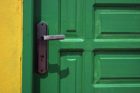 light green door with metal handle