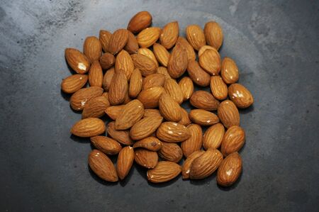 Roast almond peanut on a black skillet.の写真素材