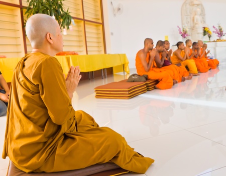 A Buddhist nun listening to chanting given by monks のeditorial素材