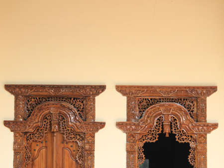 Carved and carved patterns on the walls and windows of Indonesian wooden houses, with traditional ethnic nuances that are artistic and classy.の写真素材