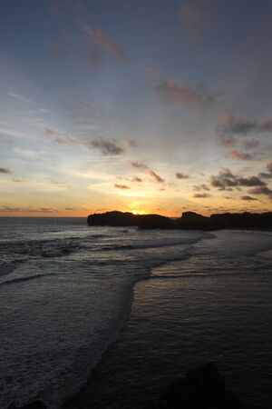 sunset at sadranan beach, yogyakarta indonesiaの写真素材