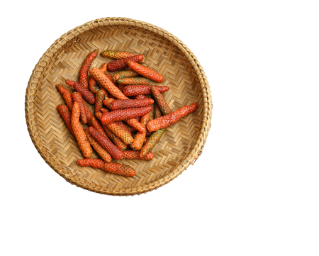 Long pepper in basket on white background, clipping maskの写真素材