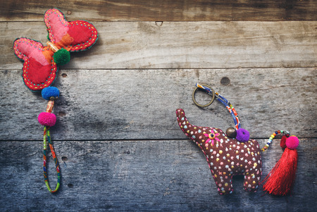 The elephant and butterfly Craft of rag on the wood backgroundの写真素材