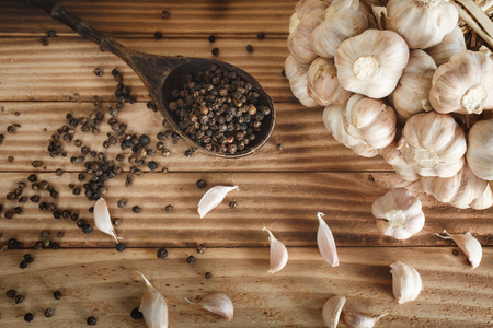 Dried Garlic and pepper on wood backgroundの写真素材