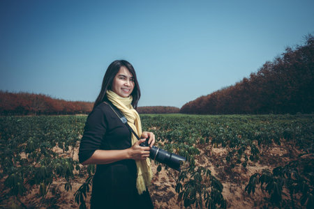 beautiful woman photographer with a camera. smile and happy, vignetting effect and hi contrast...