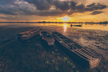 Vintage Sunset and fishing boatの写真素材