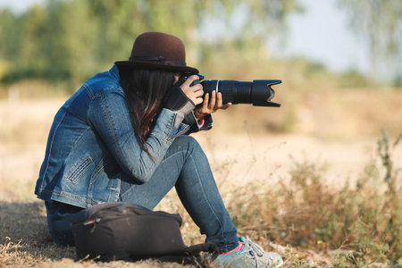 beautiful woman photographer with a camera taking photos