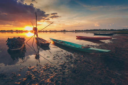 Vintage Sunset and fishing boatの写真素材