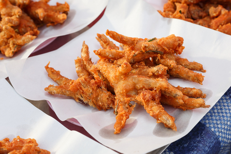tasty fried chicken at market, fried chicken foot on paperの写真素材