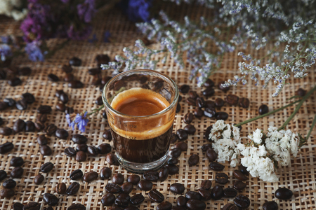 cup of coffee on coffe mug on the wood table in cafe with beans, color vintage styleの写真素材