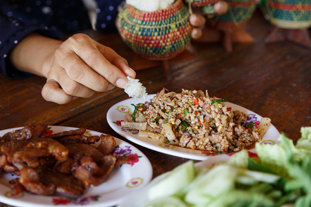 Thailand Food Lunch Sticky rice, dipping sauce mix pork herb spicy, with handの写真素材