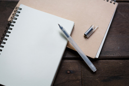 Pen and recycle notebook on wood backgroundの写真素材