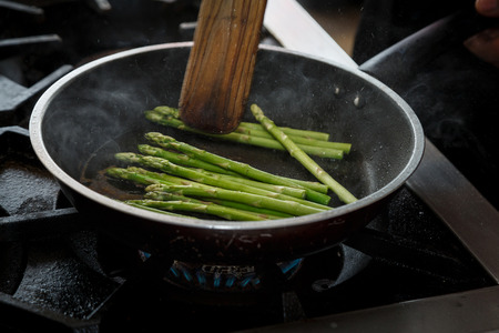 How to cook a stir fry.  motion asparagus stir fry in the panの写真素材