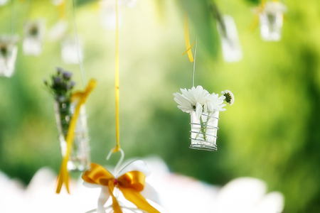 Beautiful flowers in the glass bucket. Decorated in celebration. with blur background and soft focusの写真素材
