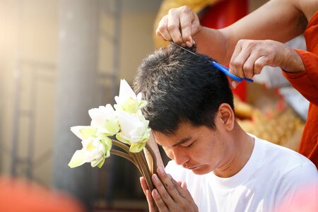 Young men remove hair to the ordination ceremony. The tradition of Buddhist monk.の写真素材