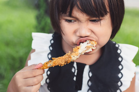 Girls eating fried chicken, Is her delicious mealの写真素材