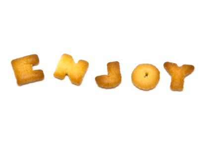 Biscuits letters. word ENJOY, on white background.の写真素材