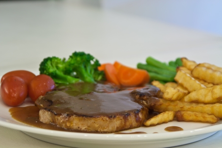 Pork Steak, tomato, broccoli, carrot and french friesの写真素材