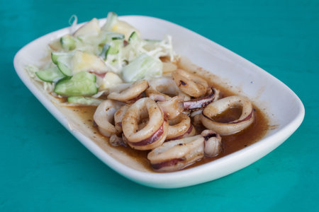 Fried squid with butter sauce served with salad.