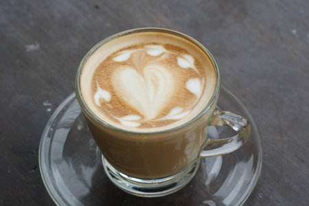 Hot coffee latte in on a wooden brown.の写真素材