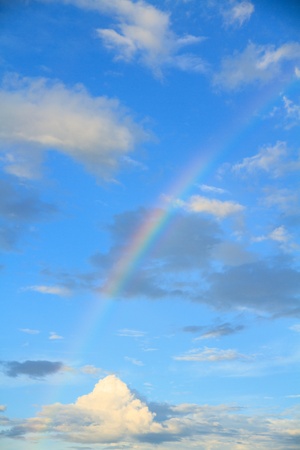 Rainbow, blue sky and white clouds の写真素材