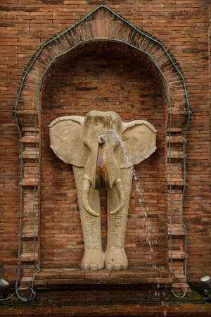 Elephant Statue spray water on the brick walls.の写真素材