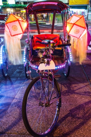 Thailand on a tricycle adorned with lamps.の写真素材