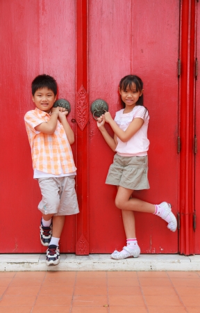 Boys and girls enjoy the front door red.の写真素材