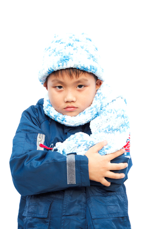 Boys in sweaters, hats and scarves on a white background.の写真素材