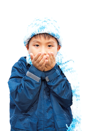 Boys in sweaters, hats and scarves on a white background.の写真素材
