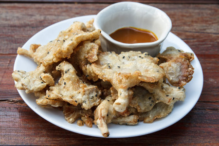 Fried mushroom and sauce on white plate.