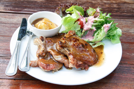 Pork Steak, mashed and salad on white plate.の写真素材