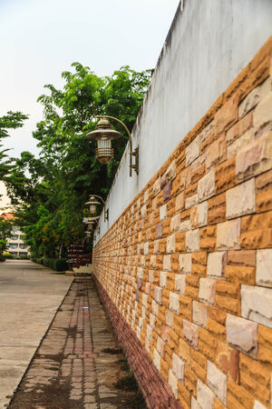 Lamp on the wall on the walkpath.の写真素材