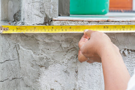 Workers were tape on pile in houses.の写真素材