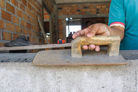 Workers were plastering on wall in houses.の写真素材