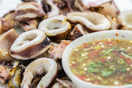 Grilled squid and spicy sauce on の写真素材