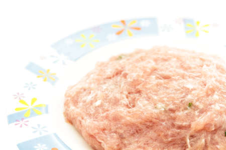 Raw mashed pork in plate on a white background.の写真素材