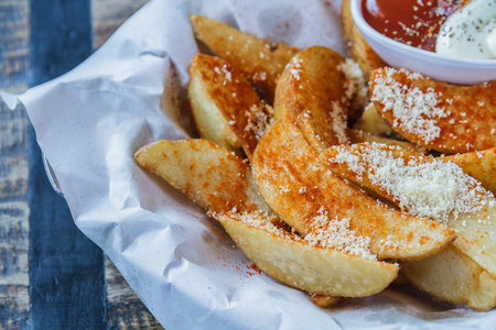 French fries sprinkle with cheese and ketchup in restaurant.