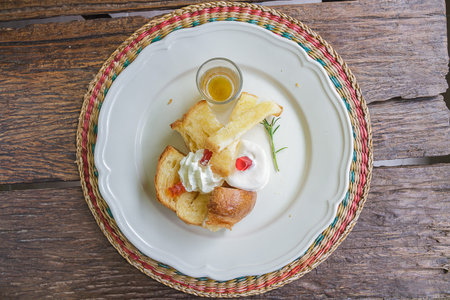 Bread grill and ice cream on white plateの写真素材