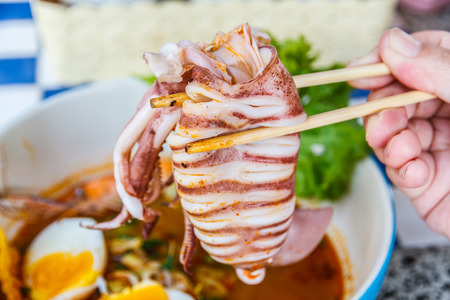 Thai local food: Noodles seafood spicy is Hot noodles add squid, shrimp, egg and meat ball.の写真素材