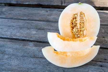 Cantaloupe slice on wood table. wooden background.の写真素材