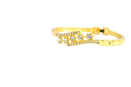 Gold bracelets adorned with diamonds. Fake jewelry. Clipping path in picture.